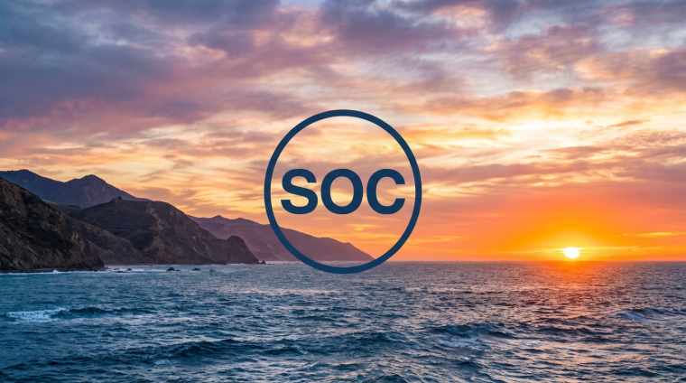 Sunset over California’s Pacific coastline with ocean waves and rugged cliffs, featuring a circular navy “SOC” graphic representing Sable Offshore Corp. (NYSE: SOC).